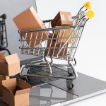 Online shopping tips - Shipping boxes in trolley on laptop